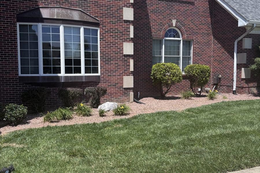 Completed Metro East residential landscape project with clean lawn and planting beds